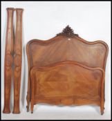 A 19th century French walnut double bed. The head and footboard having shaped toprails with carved