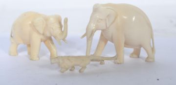 A group of three 19th century ivory carvings, two in the form of elephants and on miniature