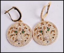 A pair of Cartier style silver gilt earrings in the form of tigers with CZ stones and green stone