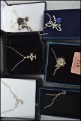 A collection of silver necklaces and pendants all