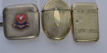 A group of three 19th century silver white metal vesta cases on of oval from with chased decoration,