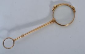 An early 20th century Edwardian pair of lorgnettes of yellow metal construction having a bail loop