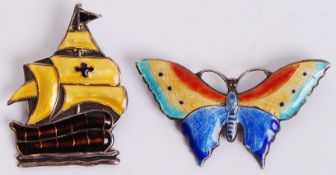 Two 1930's Scandanavian silver, white metal and enamel brooches. The first in the form of a Viking /