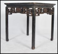 A 19th century Chinese lacquered and chinoserie decorated centre table. Painted black with gilt