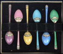 A set of six cased enamel gilt silver hallmarked coffee spoons, each in a different colourway with