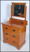 An Edwardian Arts & Crafts satin walnut dressing chest table. Raised on a plinth base with a swing