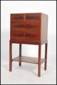A late 19th / early 20th century mahogany two over three chest of drawers on stand raised on four