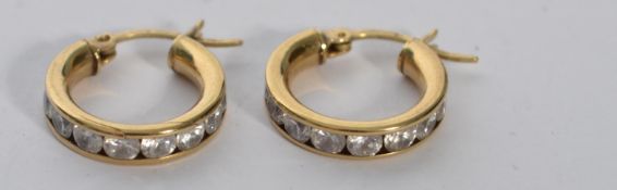 A pair of 9ct gold and white stone earrings. Marked 375, tests 9ct gold. Total weight 3g