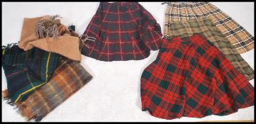 A collection of vintage and retro 20th century ladies tartan skirts, several colours and designs
