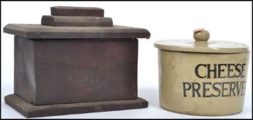 A vintage lidded ceramic cheese preserver with notation to front in bold black lettering reading