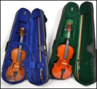 Two vintage 20th century violins complete in carry cases with bows.