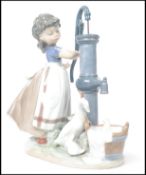 A Lladro ceramic figurine group entitled ' Summer on the Farm  ' depicting a girl with bow to hair
