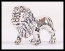 A sterling silver figurine of a male lion with detailed mane, weighs 14.4 grams.