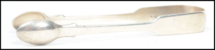 A 19th century silver hallmarked Victorian pair of sugar tongs of simple form having fiddle handle