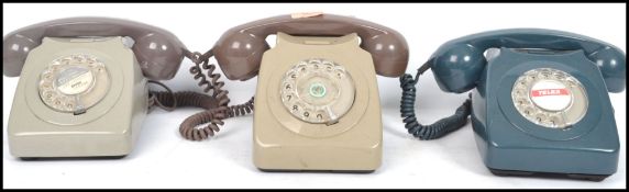 A group of three vintage 20th century ring dial telephones having phones atop. Measures: 23cm high x