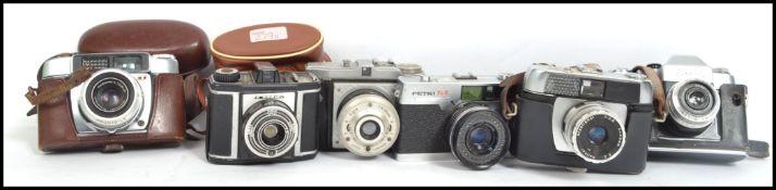 A collection of 6 vintage 20th century SLR camera's to include Zenit 3M, Haliner, Petri 7S II,