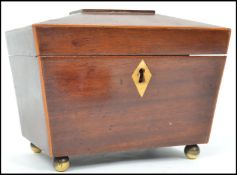 A 19th Century mahogany tea caddy, of sarcophagus form hinging to reveal a twin lead lined