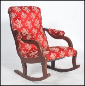 A Victorian mahogany rocking chair / armchair bein