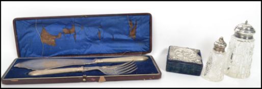 A group of silver hallmarked items to include a cut glass sugar shaker / sifter being hallmarked