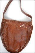 A vintage 20th century snake skin hand bag along with a matching attached purse. Measures: 62cm high