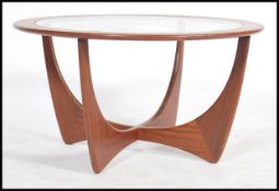 A retro teak wood atomic 'Astro' circular coffee table by G Plan, having a drop centre glass