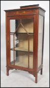 An Edwardian mahogany stencil decorated china display cabinet raised on squared legs with astragal