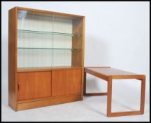 A retro 20th century teak wood coffee table of rectangular form raised on square legs together