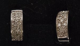 A pair of hallmarked 9ct white gold and diamond hoop earrings. Weight 3.9g.