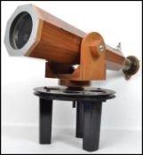 An unusual large wooden telescope of tapering form raised on a revolving large circular plinth,