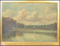 A 19th century framed oil on canvas English School painting of a lake scene surrounded by trees with