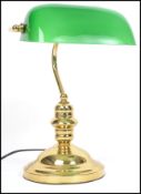 A 20th century contemporary green glass and brass bankers desk lamp having glass rectangular shade