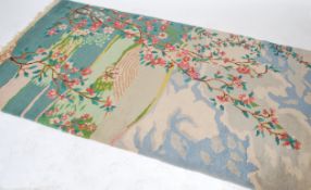 A 20th century Persian Islamic carpet rug of unusual form depicting the tree of life on a sky ground