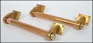 A good pair of 20th century brass vintage Art Deco cinema door handles of column form having affixed