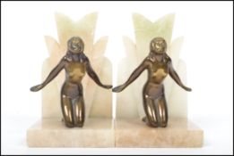 A pair of good 1930's Art Deco marble and gilt spelter nude / erotic recumbant female bookends. Each