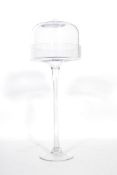 A vintage 20th century glass cake cloche stand of tall form, raised on a circular foot with tapering
