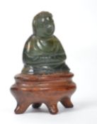 A vintage Oriental Chinese jade Buddha raised on a stone socle plinth. Measures 3.5 cms high.