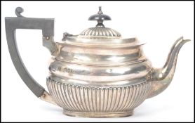 A silver hallmarked tea pot with gadrooned base and lid, London assay marks dating to 1893 with