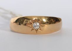 An 18ct gold hallmarked, solitaire diamond set gypsy style ring. Set with old cut diamond. Total