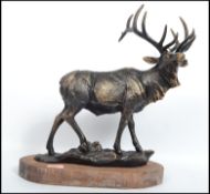 A very large vintage 20th century cast iron stag figurine raised on a naturalistic base with