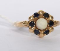 A 9ct gold hallmarked seven stone pearl and sapphire set ring, central pearl surrounded by six