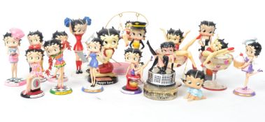A group of four vintage Betty Boop figures with dogs to include cheer leader, Carnaby Street, Pilot,