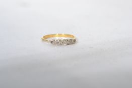 An 18ct gold diamond illustion set ladies ring. 5 illustion set diamonds on a vintage setting. Total