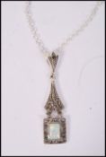 A sterling silver marcasite and opal necklace and pendant of square form, weighs 5 grams.