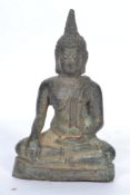 A 19th century Oriental bronze figure of a Buddha moulded in the lotus position rasied on a pedestal