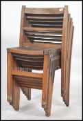A set of vintage mid century wooden stacking chairs having slatted seats with squared legs and panel
