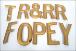 A group of vintage advertising point of sale shop display sign letters having a painted gilt finish,