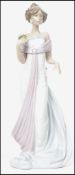 A Lladro ceramic figurine of a lady holding a flower posy entitled ' Summer Infatuation ' , number
