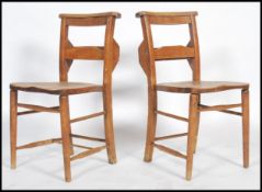 A pair of early 20th century  elm chapel chairs fitted with hymnal tray, curved top rail, turned