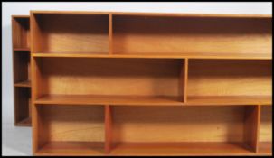 A pair of retro 20th century teak wood open bookcases of large proportions having a series of