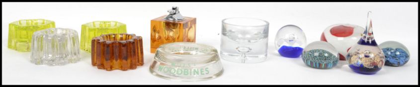 A collection of glass paperweights from the 20th century together with vintage glass piano